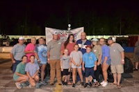 a group of people posing for a picture at night